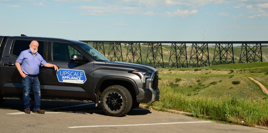 Upscale Appliance owner in front of service truck in Southern Alberta
